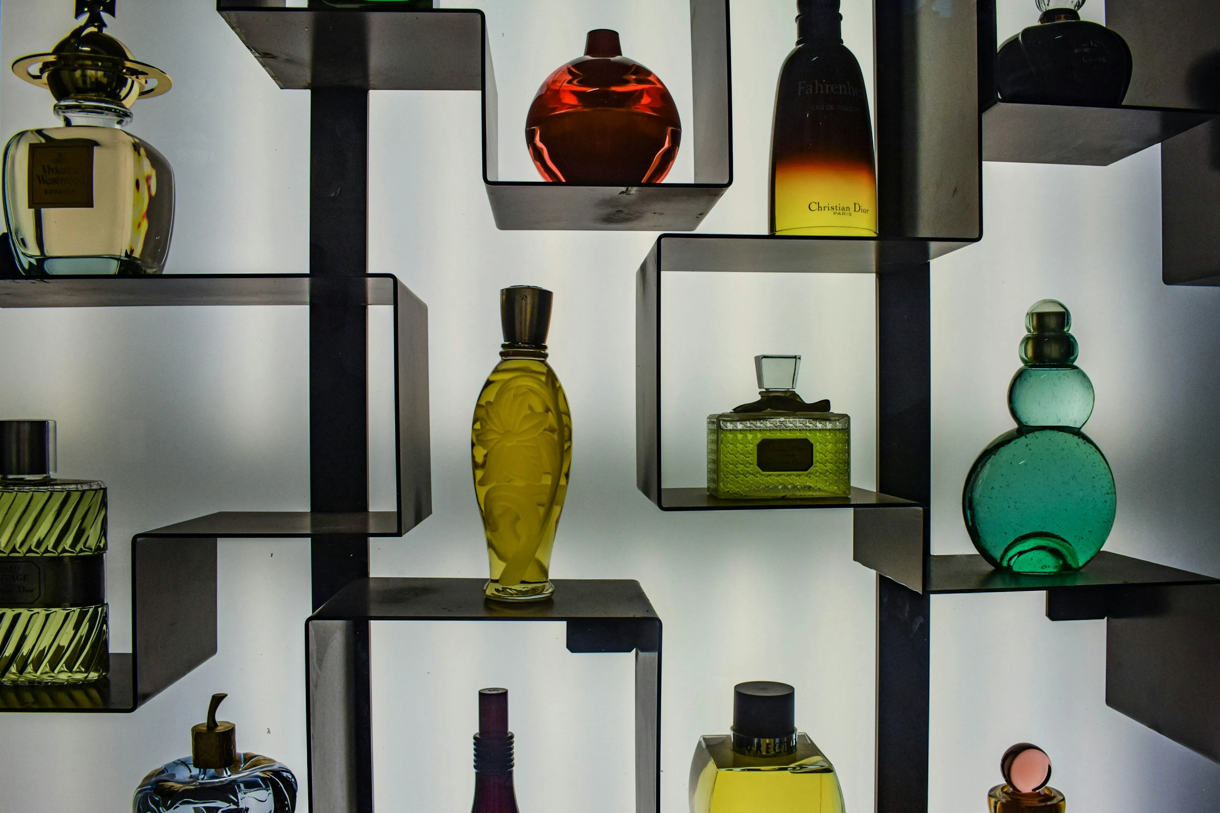A shelf displaying fragrance bottles in museum